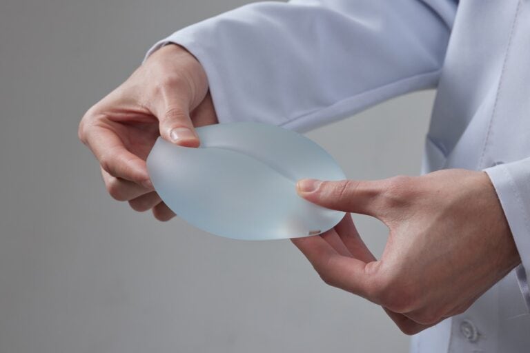 doctor showing breast implant size